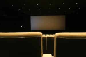 Cines en Saltillo: guía completa de todos los complejos, formatos y zonas Sala de cine con butacas rojas vacías frente a la pantalla, representa los cines en Saltillo Coahuila